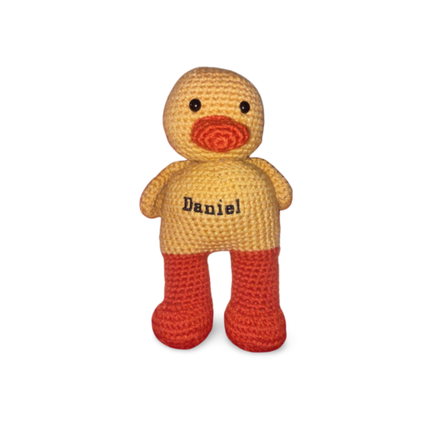 Explore the charm and craftsmanship of handmade plushies, crafted with care.These soft and cuddly companions are meant to be loved.Bright yellow and orange duck plushie.You can choose to embroid a name on it's tummy for R50.00 more.